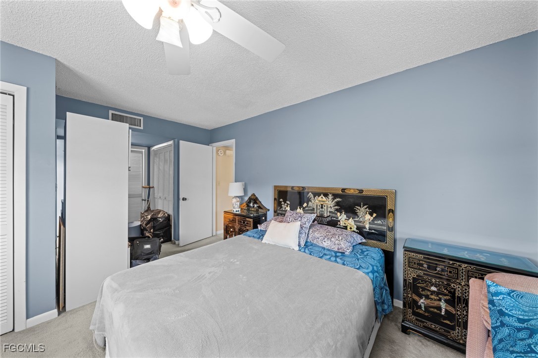 202 Bobolink Way, Unit 202B Naples, FL 34105 - Photo 21 of 31 a bed room with a bed and a large closet