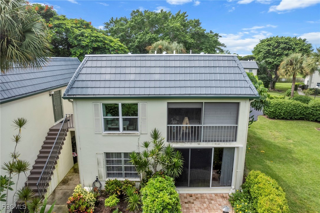 202 Bobolink Way, Unit 202B Naples, FL 34105 - Photo 30 of 31 a view of a house with a yard