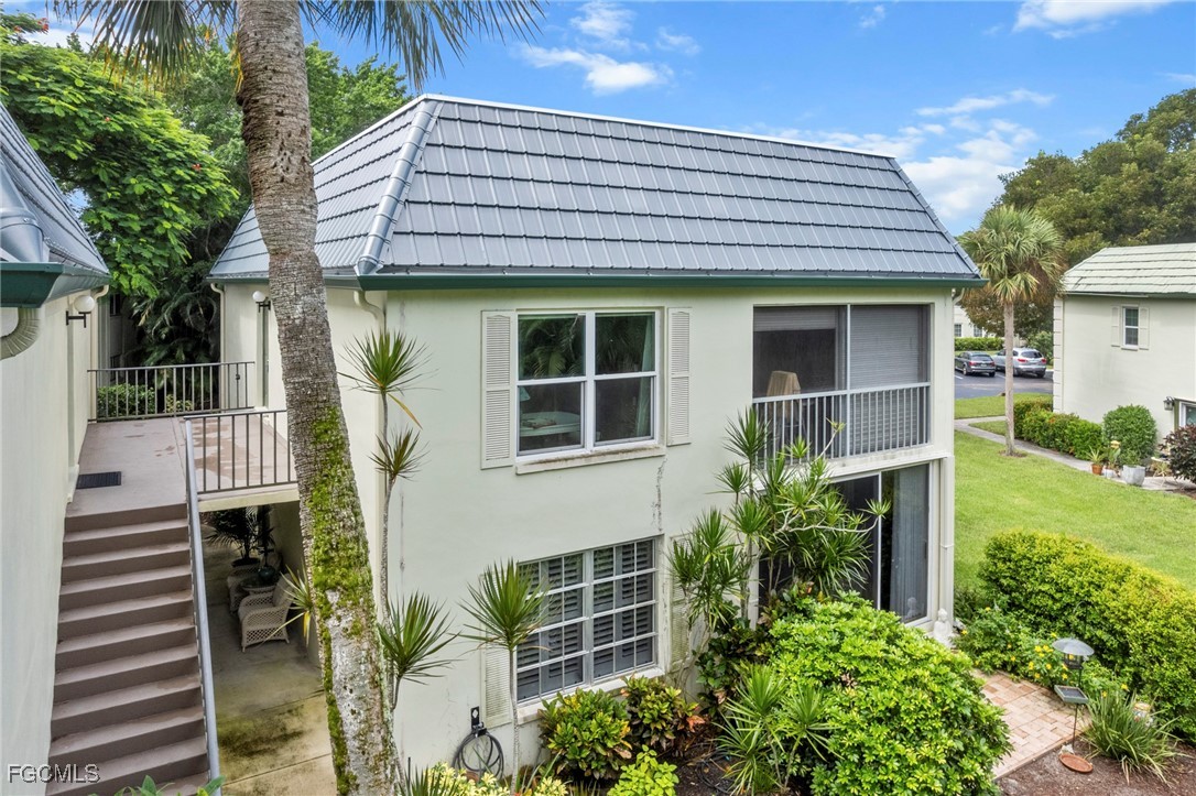 202 Bobolink Way, Unit 202B Naples, FL 34105 - Photo 31 of 31 a front view of a house with a yard