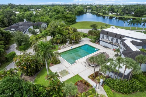 an aerial view of a house with a lake view