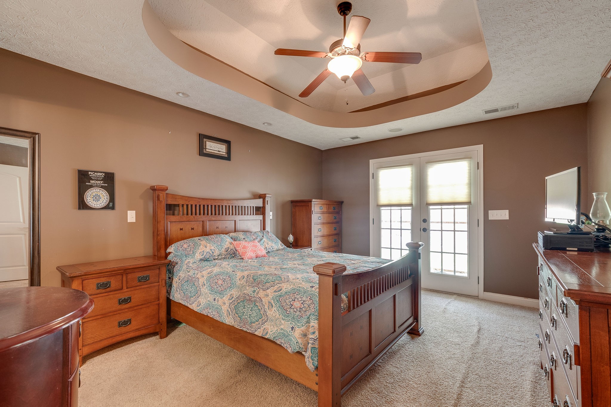 1112 Pee Dee Branch Road Cottontown, TN 37048 - Photo 20 of 33 a bedroom with a bed a chandelier fan and a large window