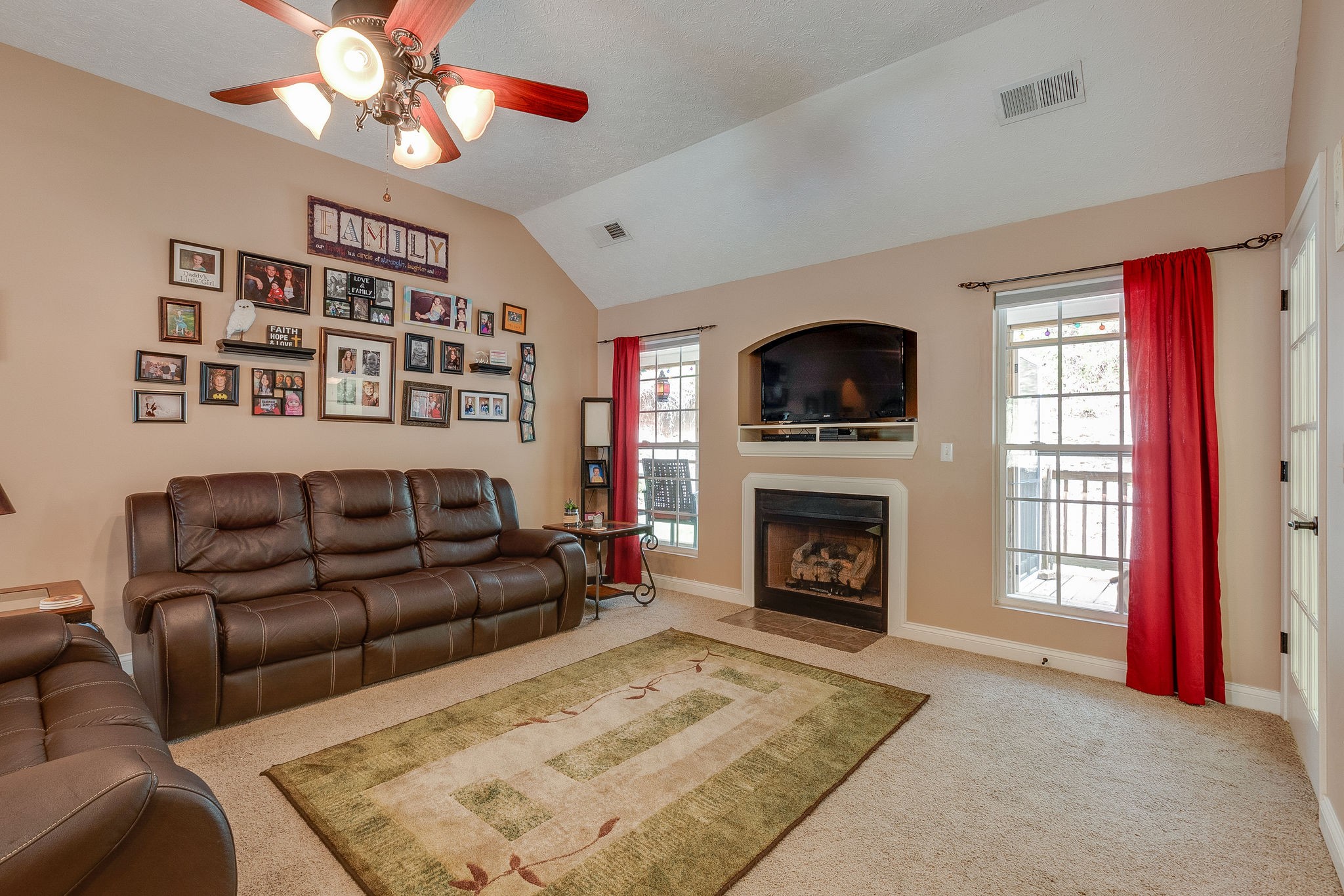1112 Pee Dee Branch Road Cottontown, TN 37048 - Photo 10 of 33 a living room with furniture a fireplace and a flat screen tv