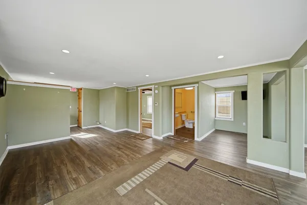 an entryway with wooden floor and cabinet