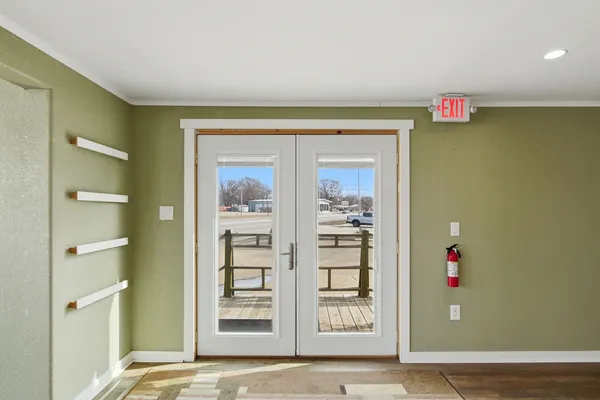 a view of front door with furniture and a large window