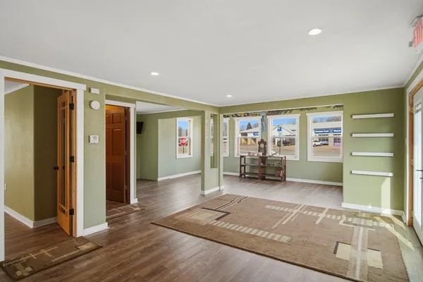 a kitchen with stainless steel appliances granite countertop a sink a stove top oven a chimney and a window