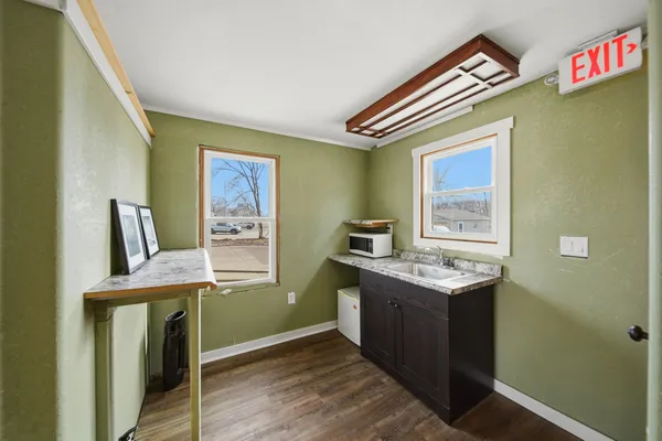 a workspace with wooden floor and a window