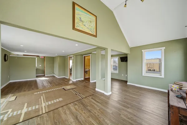 a view of a room with wooden floor and window