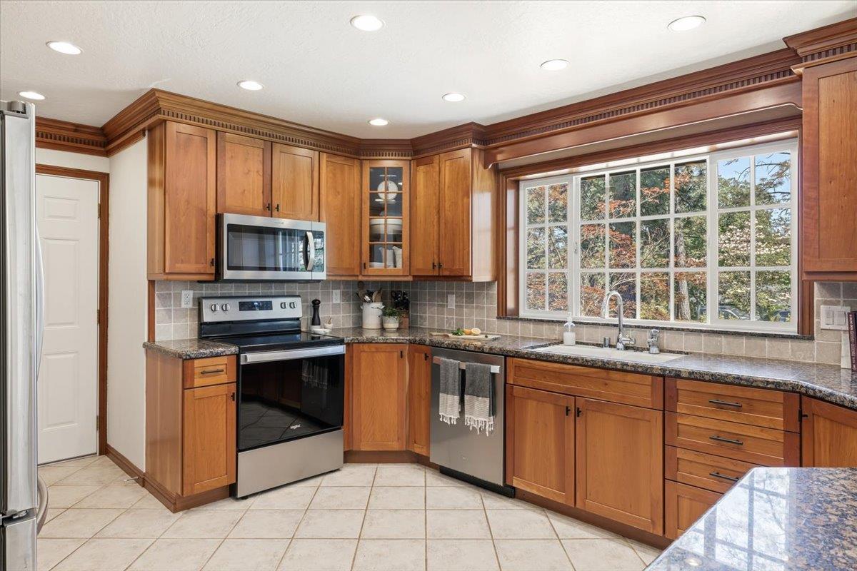 16856 Scott Way Grass Valley, CA 95949 - Photo 17 of 67 a kitchen with stainless steel appliances granite countertop a stove a sink and a microwave