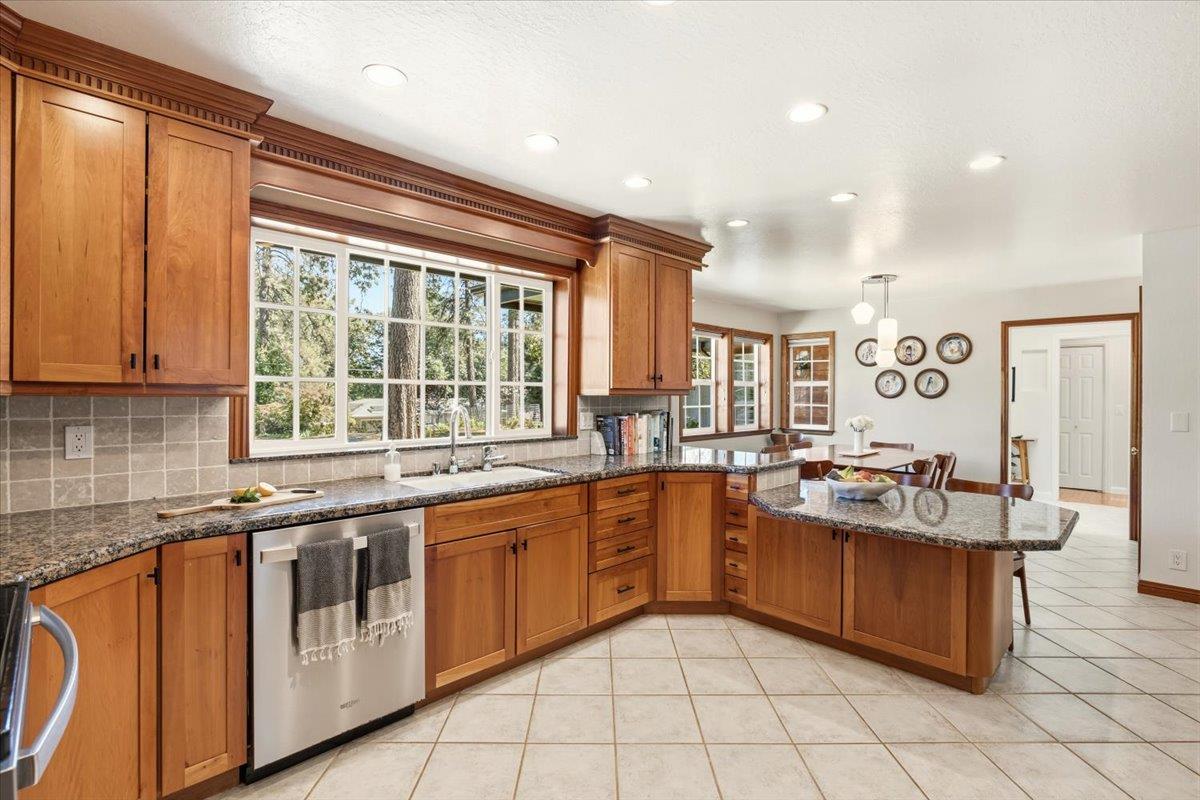 16856 Scott Way Grass Valley, CA 95949 - Photo 18 of 67 a kitchen with stainless steel appliances granite countertop stove top oven and cabinets