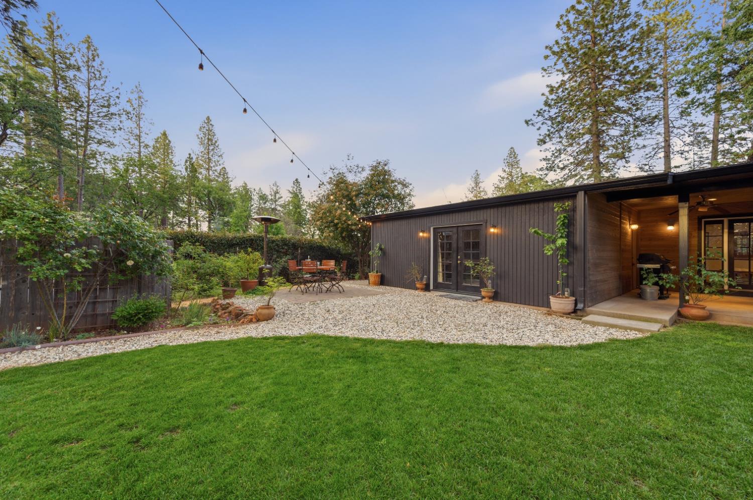 16856 Scott Way Grass Valley, CA 95949 - Photo 36 of 67 a view of a backyard with table and chairs and potted plants and large trees