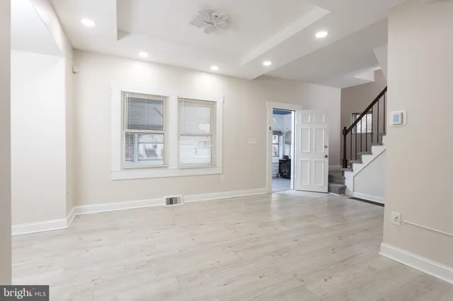 an empty room with windows and closet