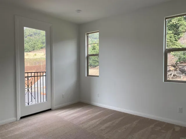 a white toilet sitting next to a window