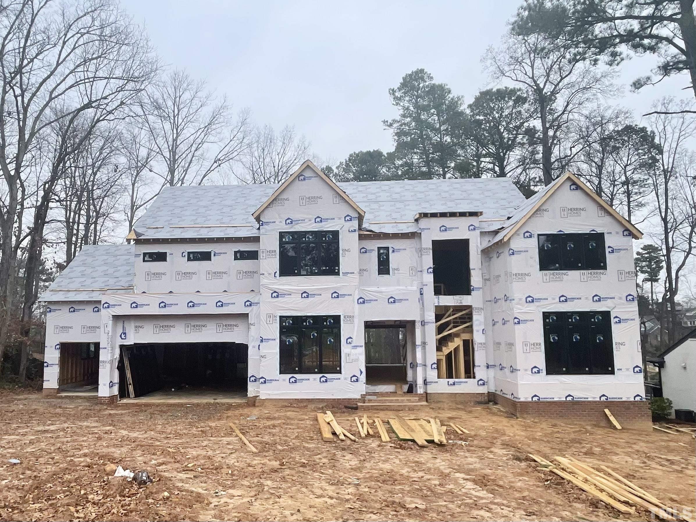 a view of a white house with large windows