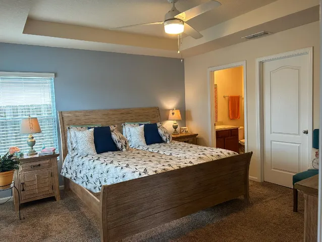 a bedroom with a bed and flat screen tv