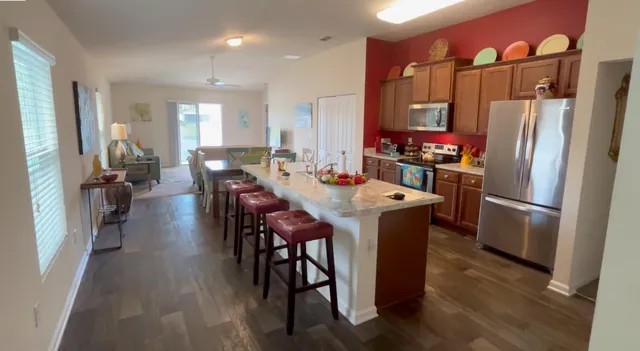 a living room with furniture a rug and a flat screen tv