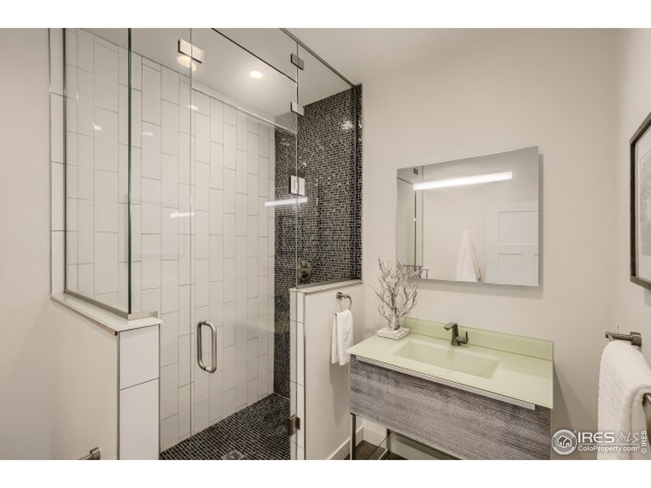 1133 Arroyo Chico Road Boulder, CO 80302 - Photo 16 of 37 a bathroom with a granite countertop sink a mirror a vanity and shower
