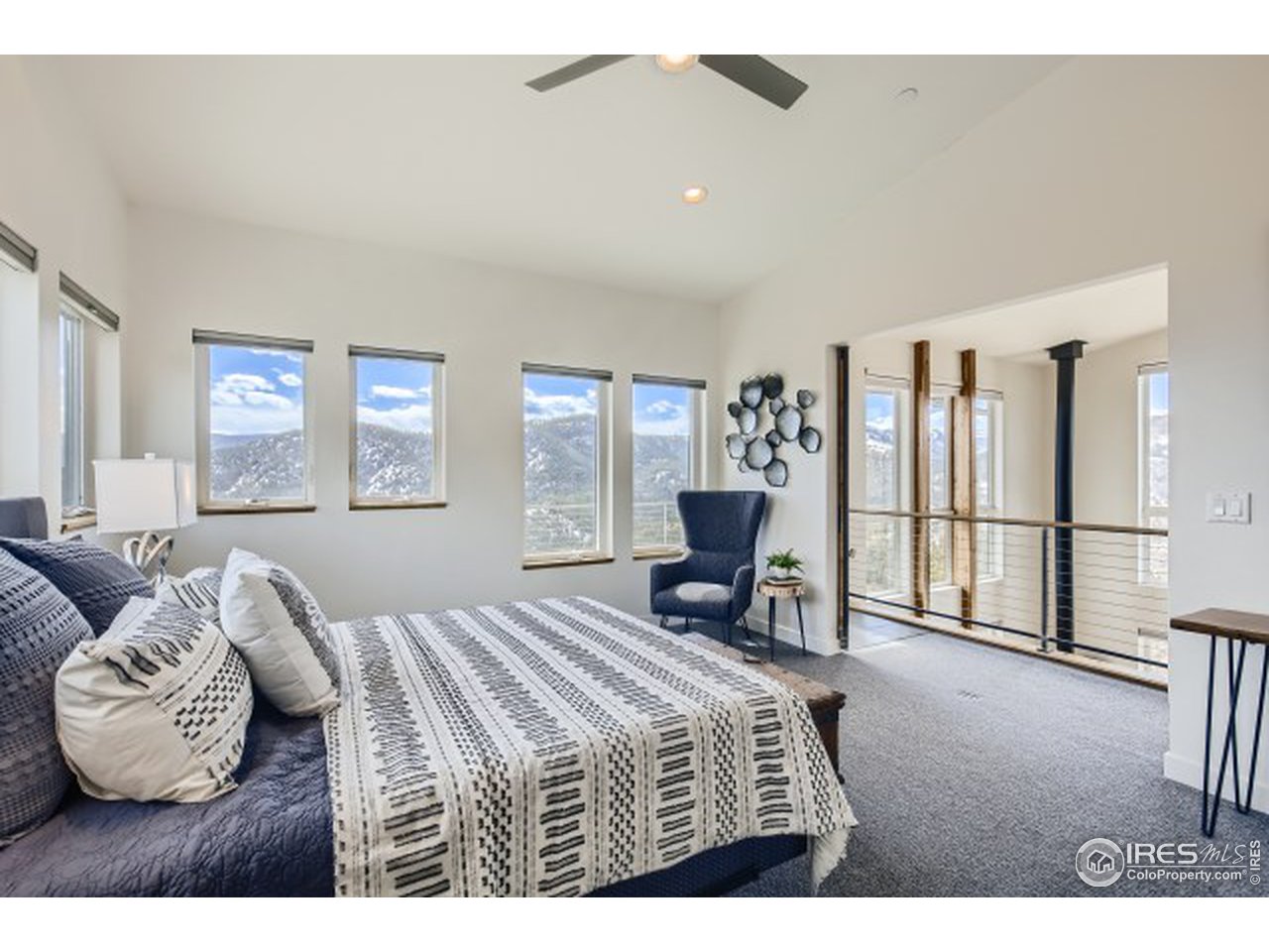 1133 Arroyo Chico Road Boulder, CO 80302 - Photo 18 of 37 a bedroom with a bed a table and chair