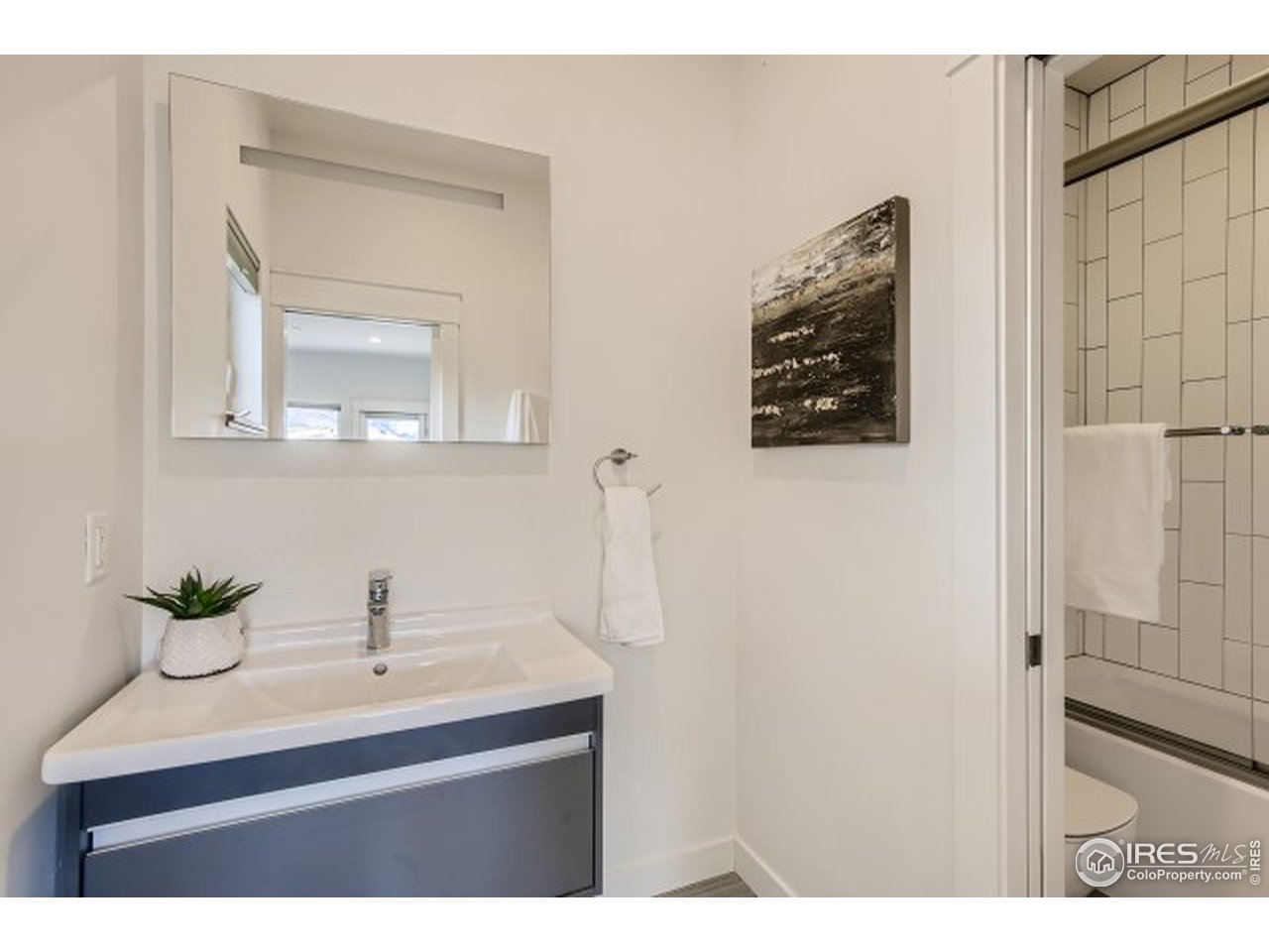 1133 Arroyo Chico Road Boulder, CO 80302 - Photo 26 of 37 a bathroom with a sink a mirror and shower