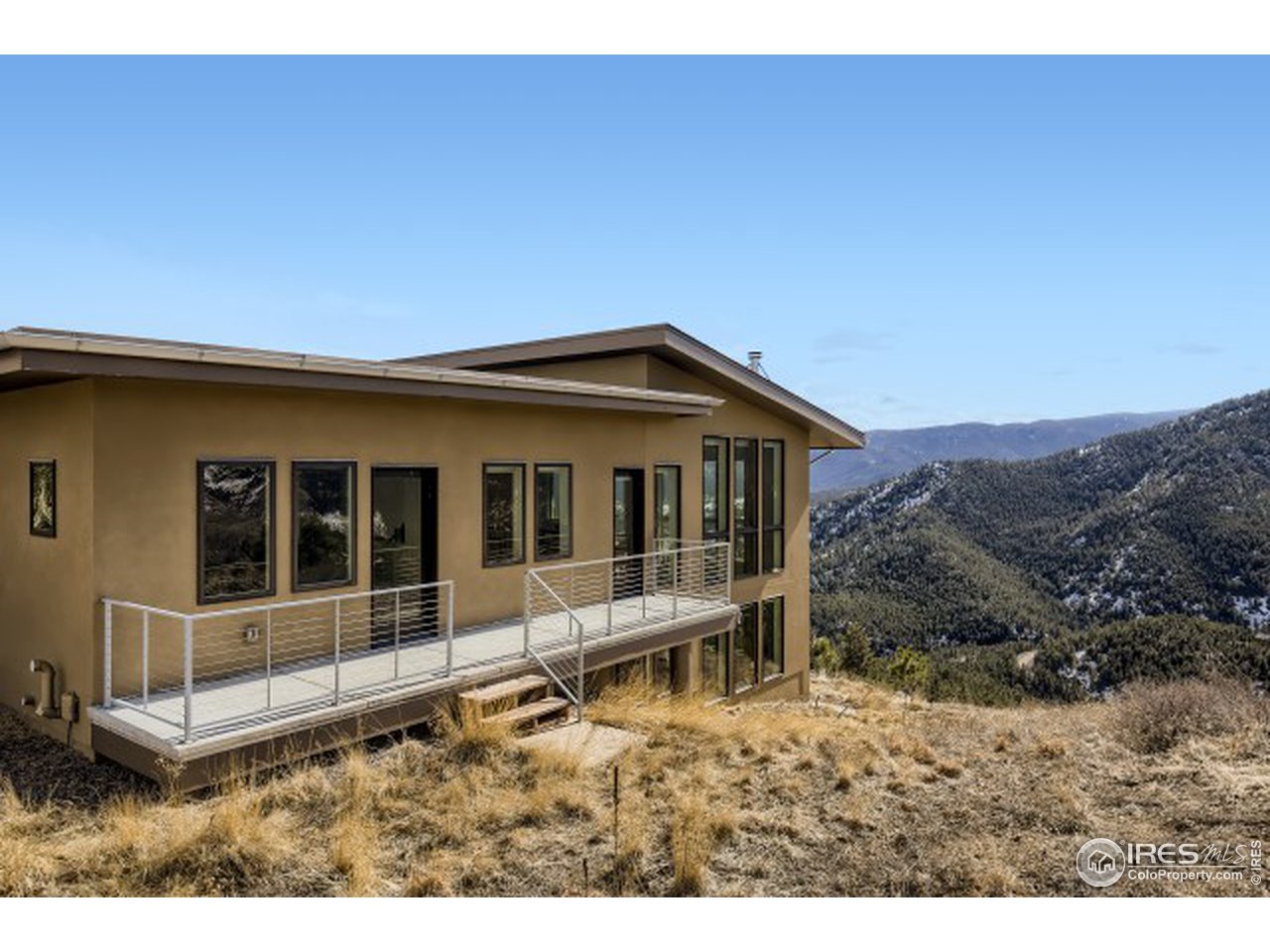 1133 Arroyo Chico Road Boulder, CO 80302 - Photo 29 of 37 a backyard of a house with a yard and outdoor seating