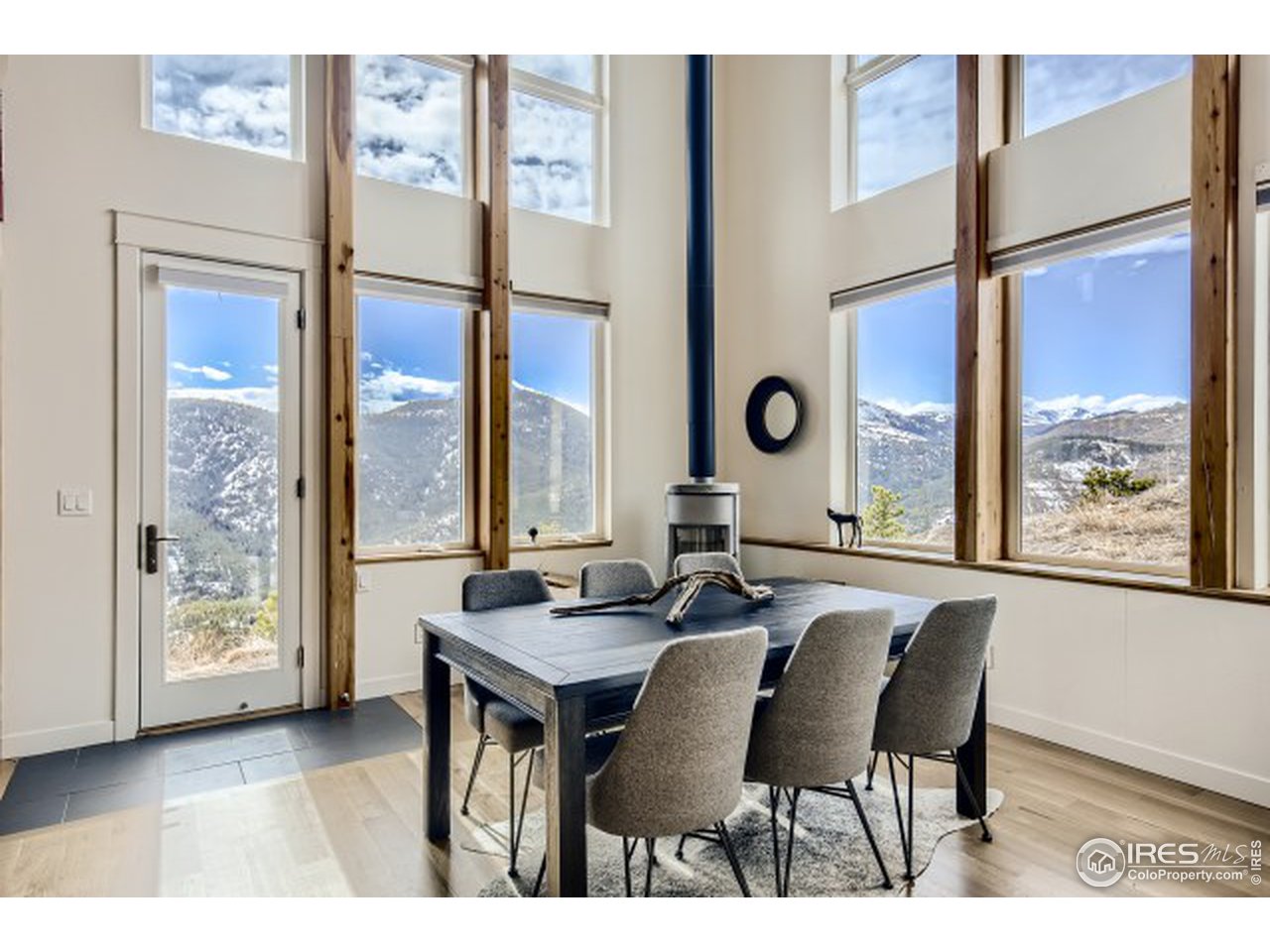 1133 Arroyo Chico Road Boulder, CO 80302 - Photo 7 of 37 a dining room with furniture and a large window
