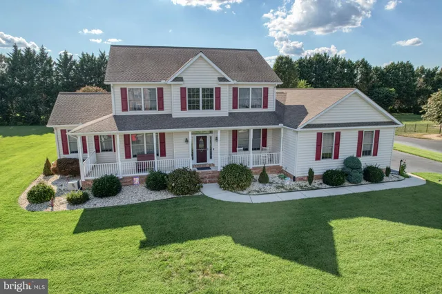 a front view of a house with a yard table and chairs