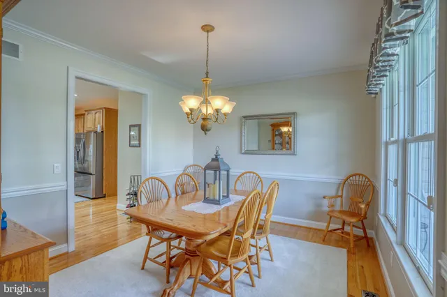 a view of a dining room with furniture and chandelier