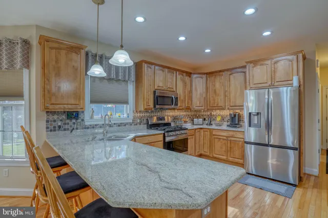 a kitchen with a refrigerator sink and microwave