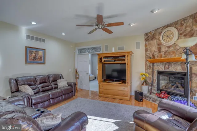a living room with furniture and a glass door