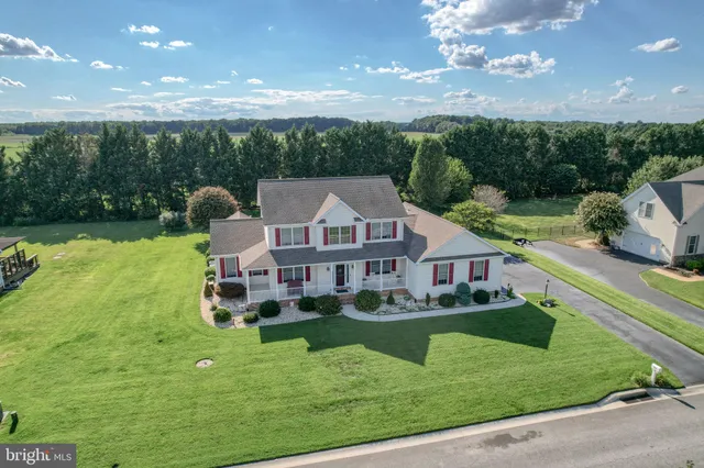 a view of a house with a yard balcony and sitting area