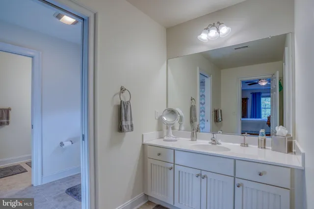 a bathroom with a double vanity sink and a mirror