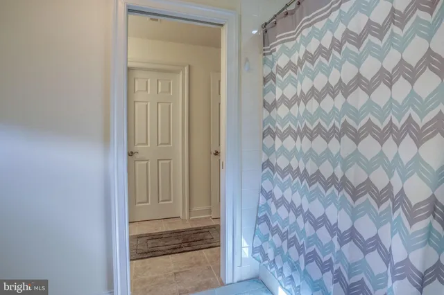 a bedroom with a bed and a ceiling fan