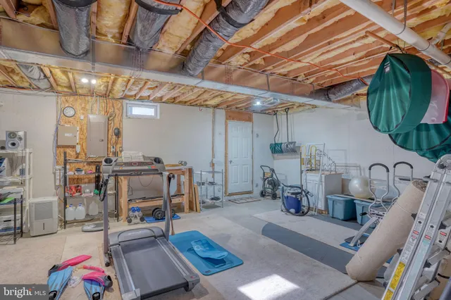 an aerial view of a house with yard and green space