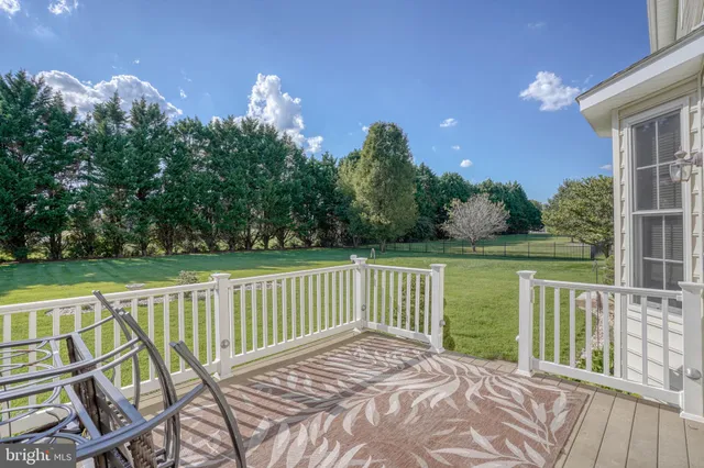 a view of a wooden deck with a yard
