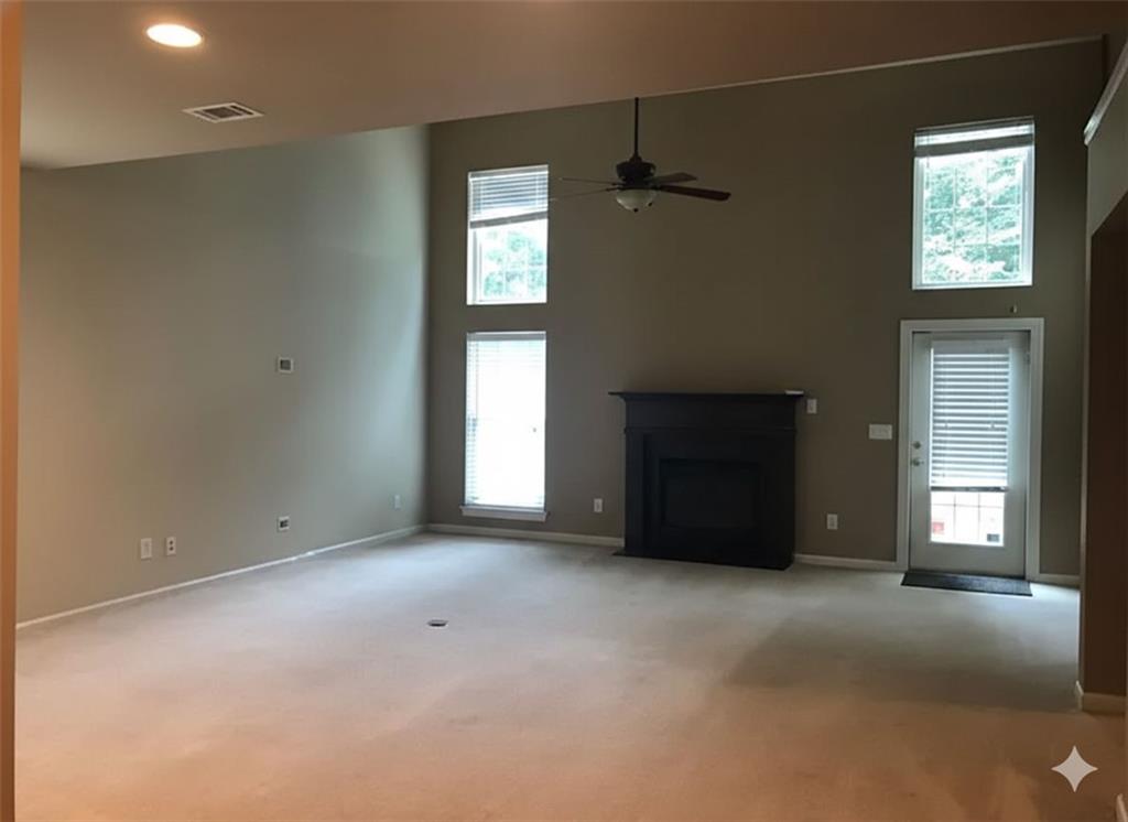 7923 Keepsake Lane Flowery Branch, GA 30542 - Photo 5 of 6 a view of an empty room with a window
