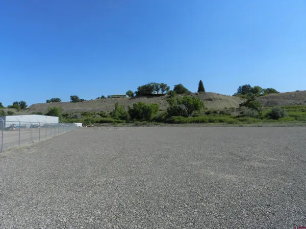 a view of a field with an ocean view