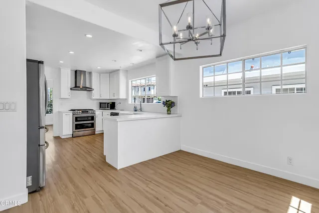 a view of a kitchen with microwave and cabinets