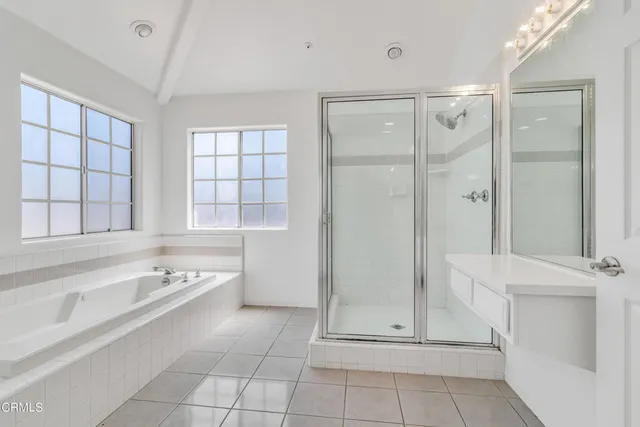 a bathroom with a tub shower and sink