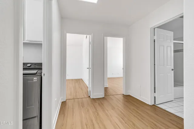 a view of hallway with wooden floor