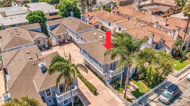 an aerial view of a house with a yard and potted plants