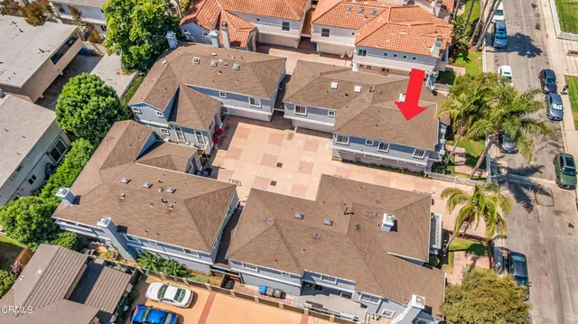 an aerial view of residential houses with outdoor space