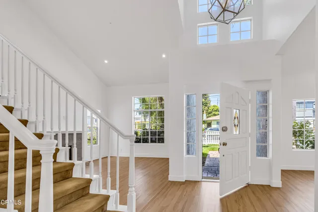 a view of an entryway with wooden floor and windows
