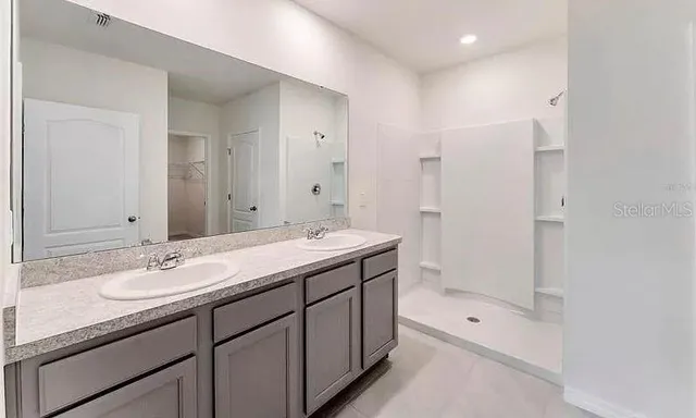 a view of bathroom with a shower sink mirror and toilet