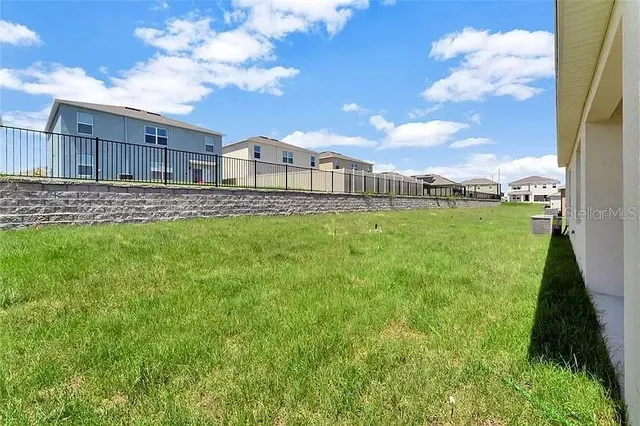a view of a backyard with plants and a garden