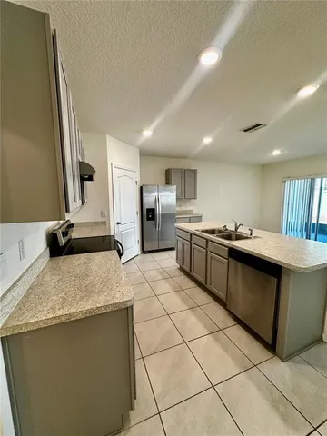 a kitchen with stainless steel appliances a refrigerator and a stove top oven