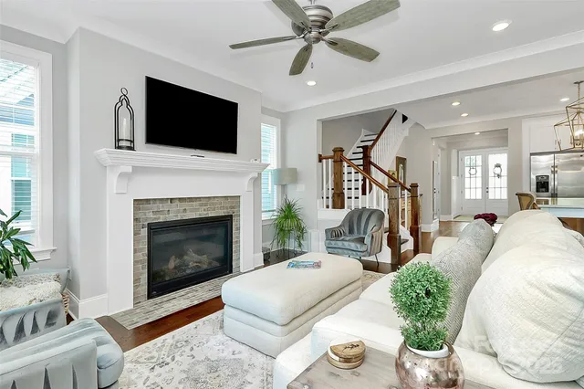 a living room with furniture a flat screen tv and a fireplace