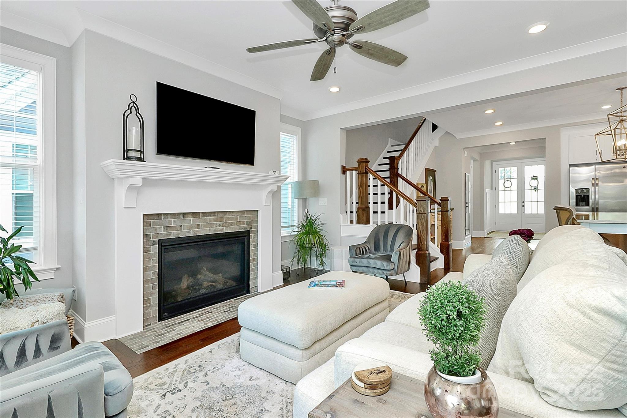 136 Preston Road Mooresville, NC 28117 - Photo 12 of 46 a living room with furniture a flat screen tv and a fireplace