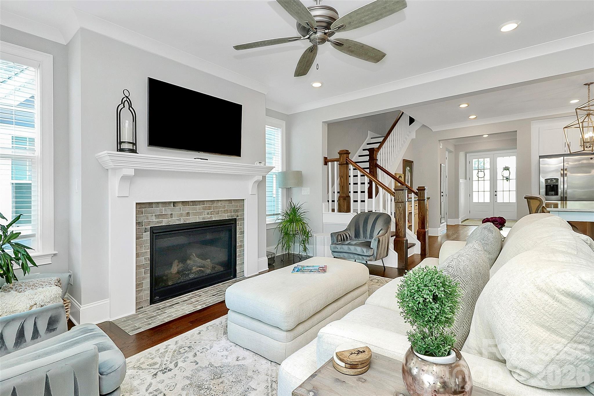 136 Preston Road Mooresville, NC 28117 - Photo 13 of 46 a living room with furniture a flat screen tv and a fireplace