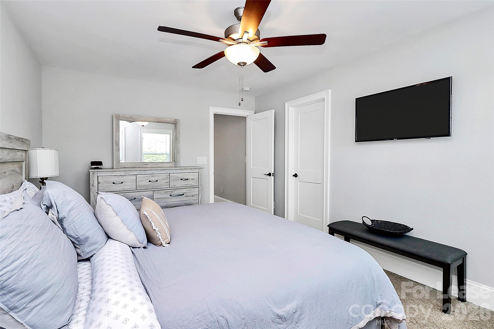 136 Preston Road Mooresville, NC 28117 - Photo 17 of 46 a bedroom with a bed and a flat screen tv