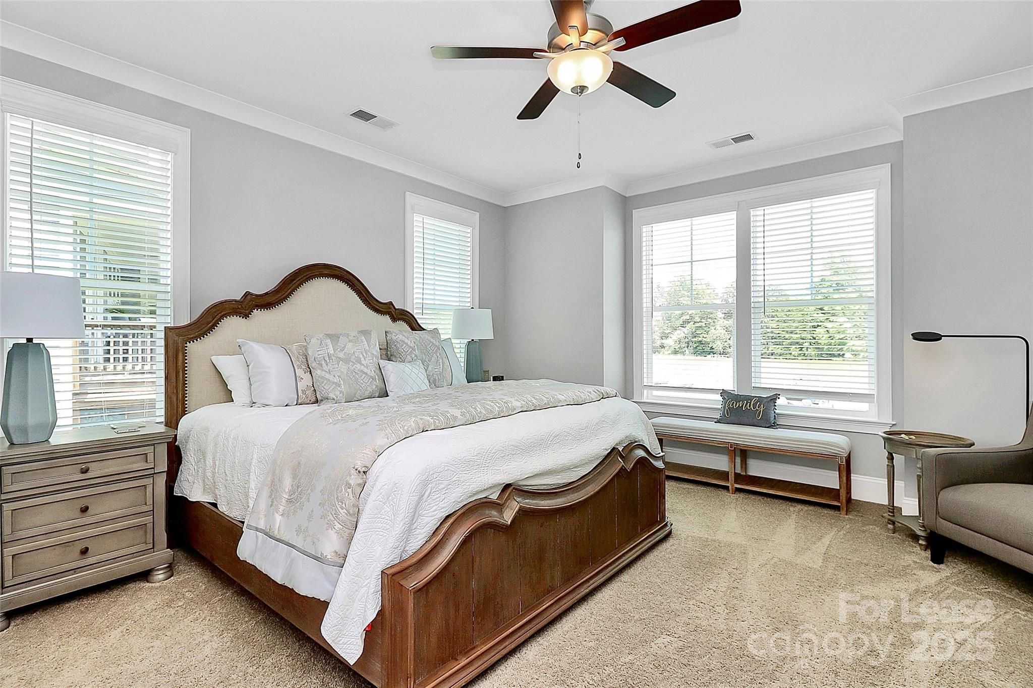 136 Preston Road Mooresville, NC 28117 - Photo 18 of 46 a spacious bedroom with a bed and a chandelier