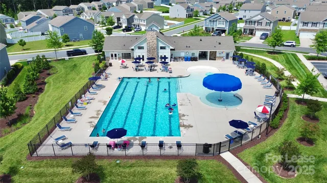 an aerial view of a swimming pool patio and outdoor seating